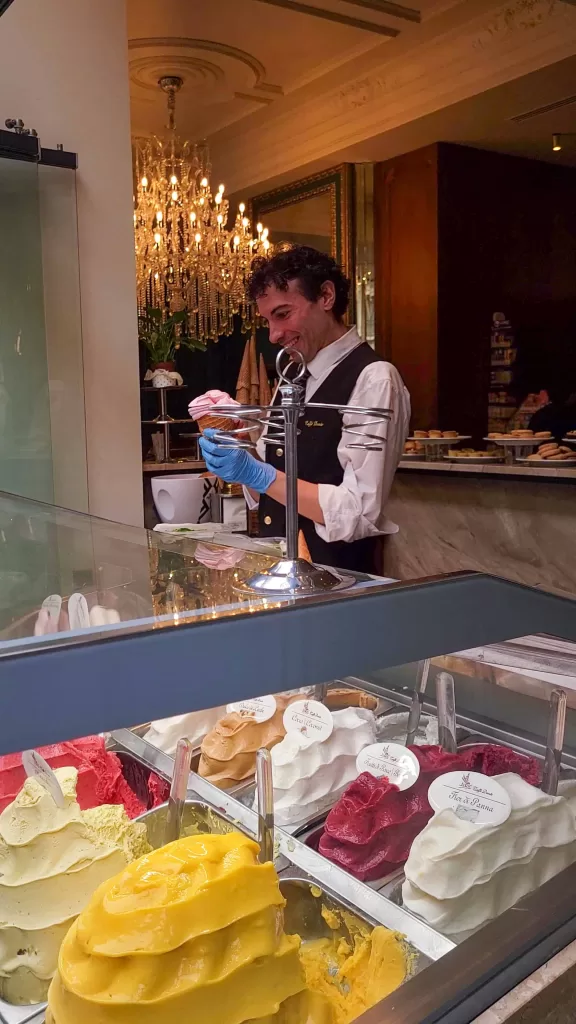 A server making a beautiful gelato cone at cafe dante in milan