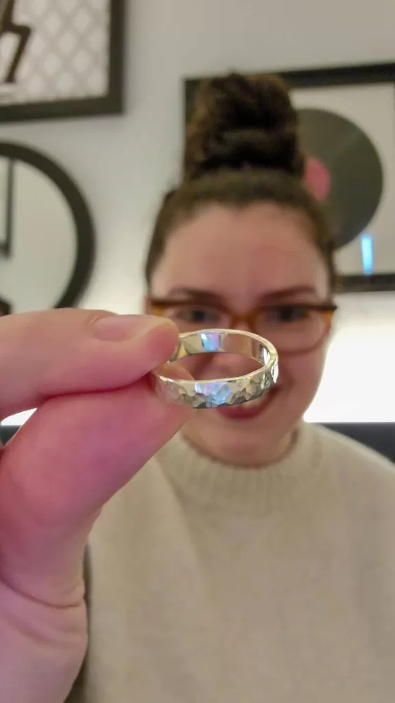 me holding a silver ring I made at the silver ring forging workshop in dublin