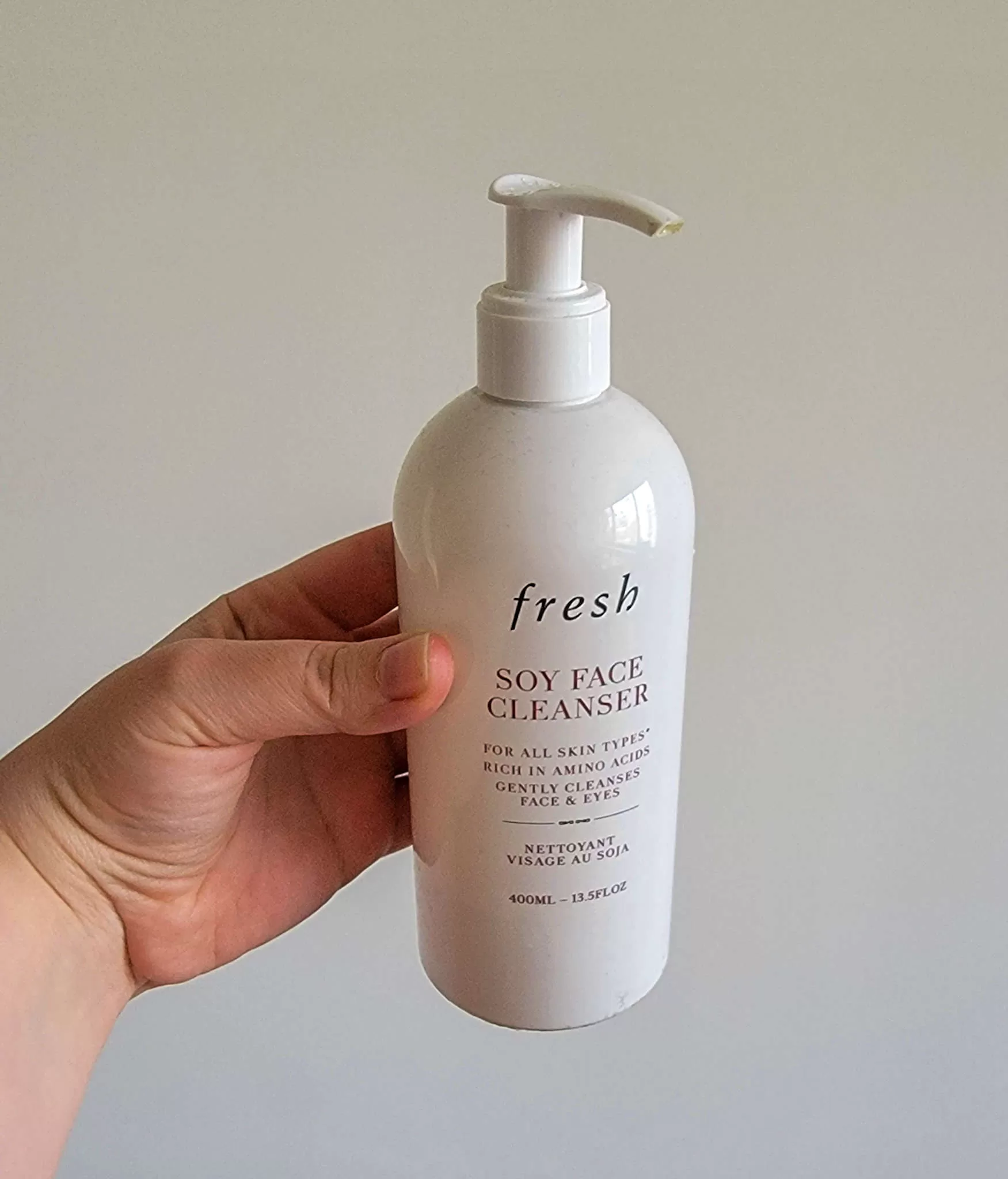 bottle of face cleanser, on the list of travel essentials for women