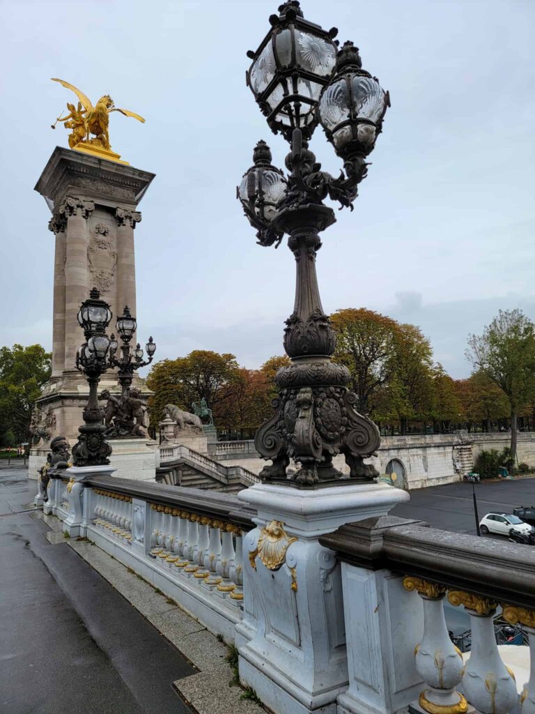 lamp and statue that decorate pont alexandre III in paris