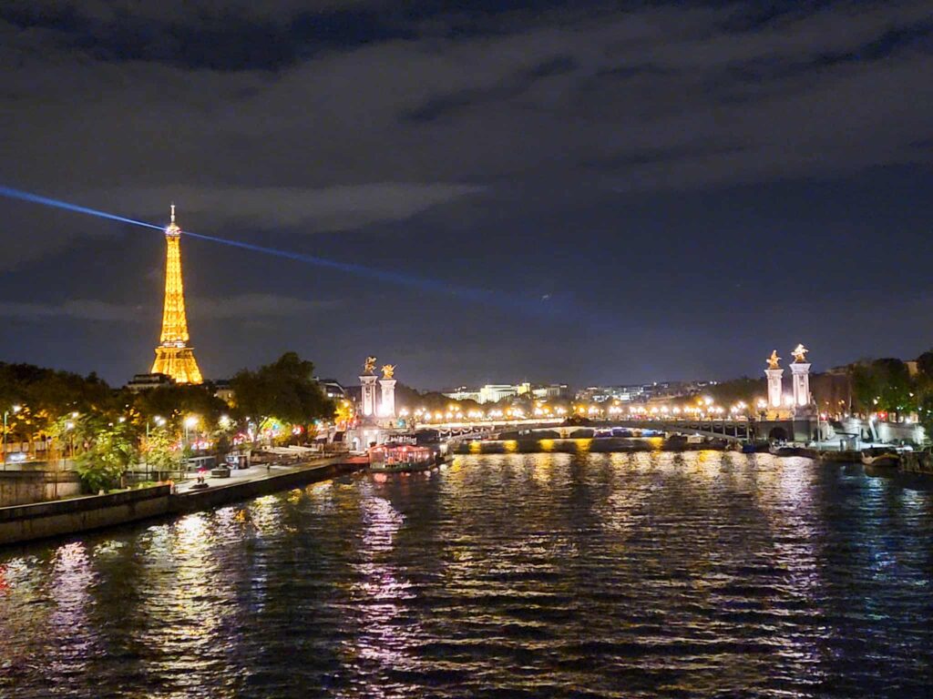view of the eiffel tower and the seine at night