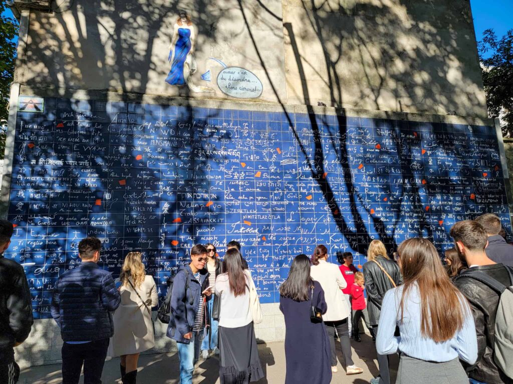 a blue wall which has "I love you" written on it in all languages