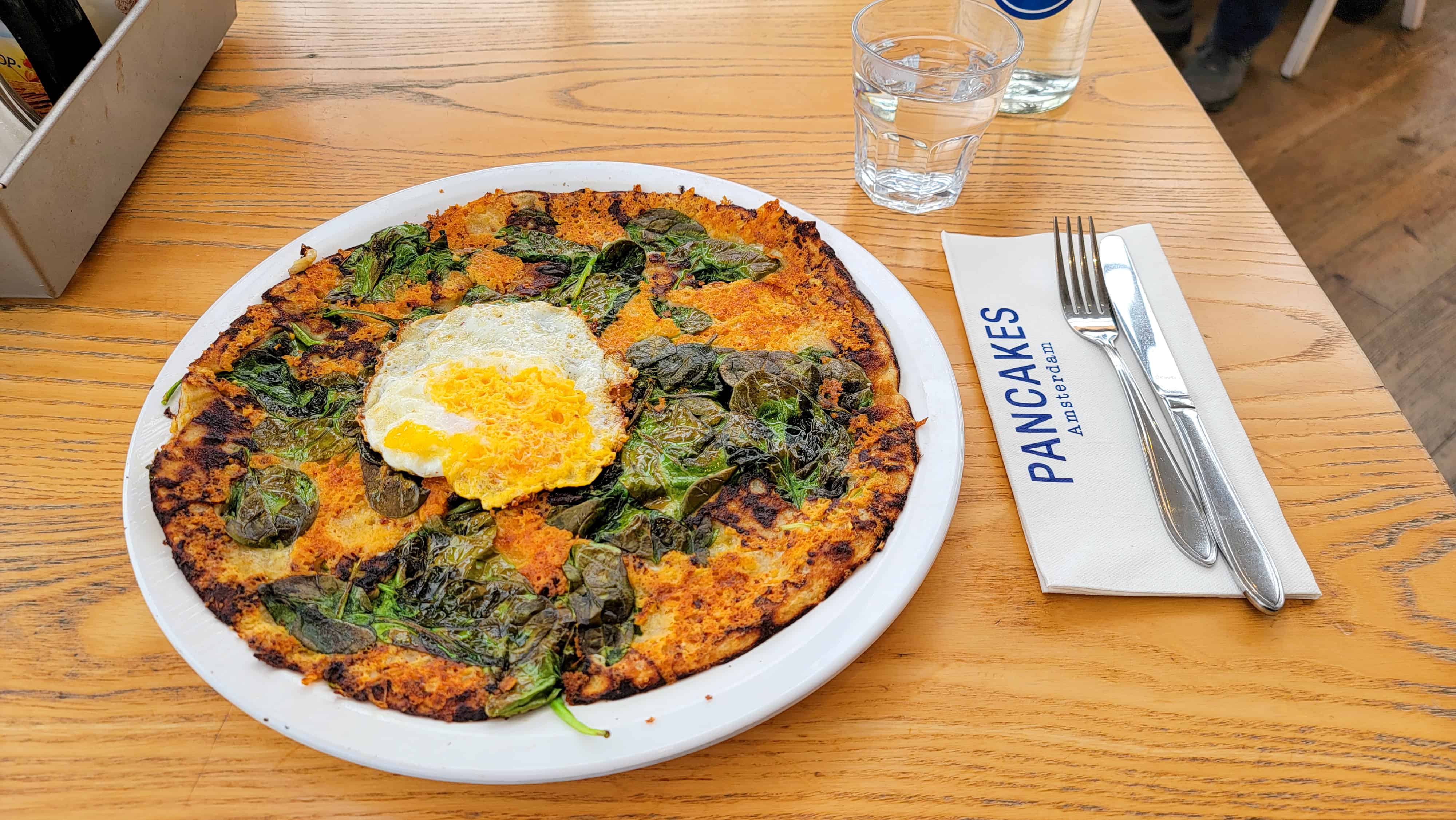a dutch pancake with cheese, egg and spinach