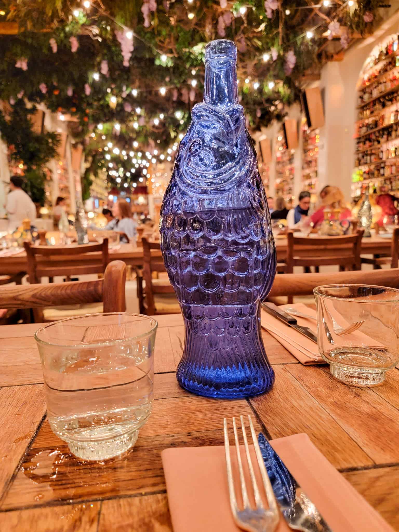 water bottle that looks like a fish and the interior of circolo popolare restaurant in london