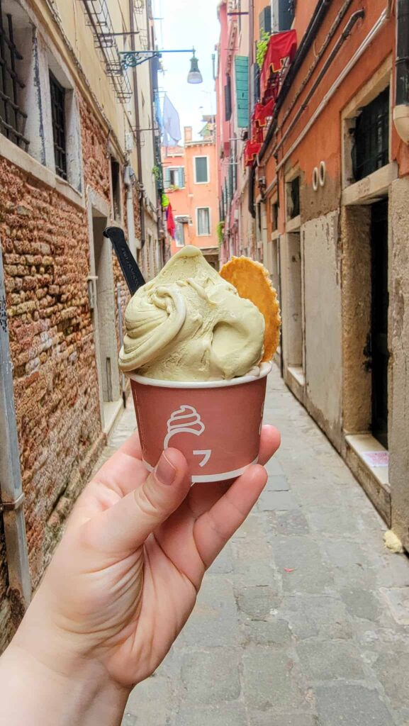 me holding a cup of gelato in venice