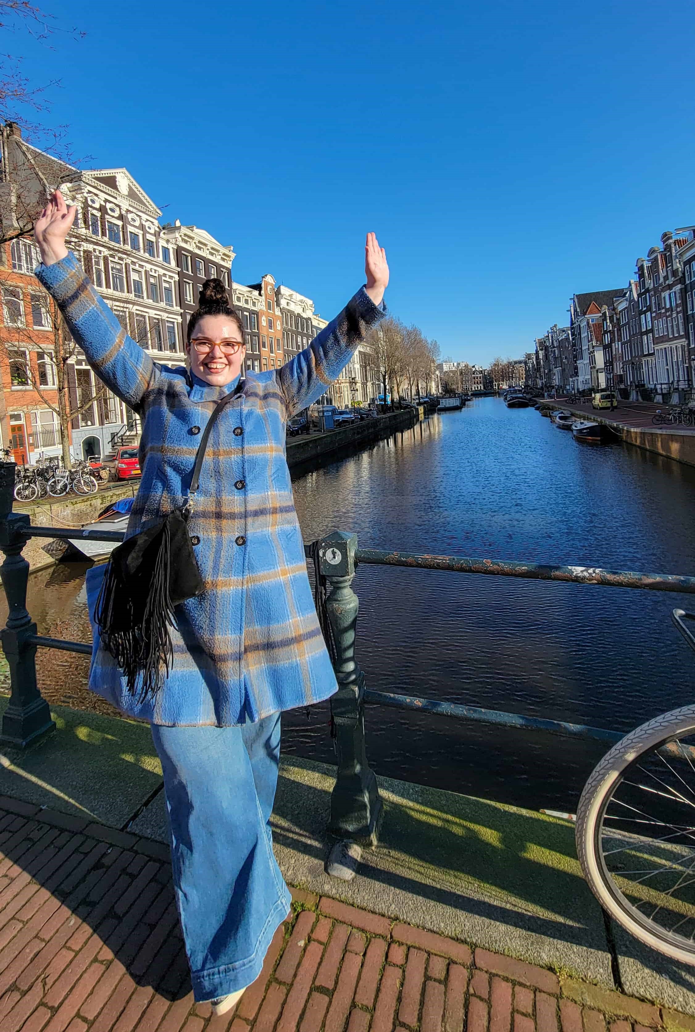 me in front of a canal in amsterdam; the first picture i took on my solo travel to amsterdam