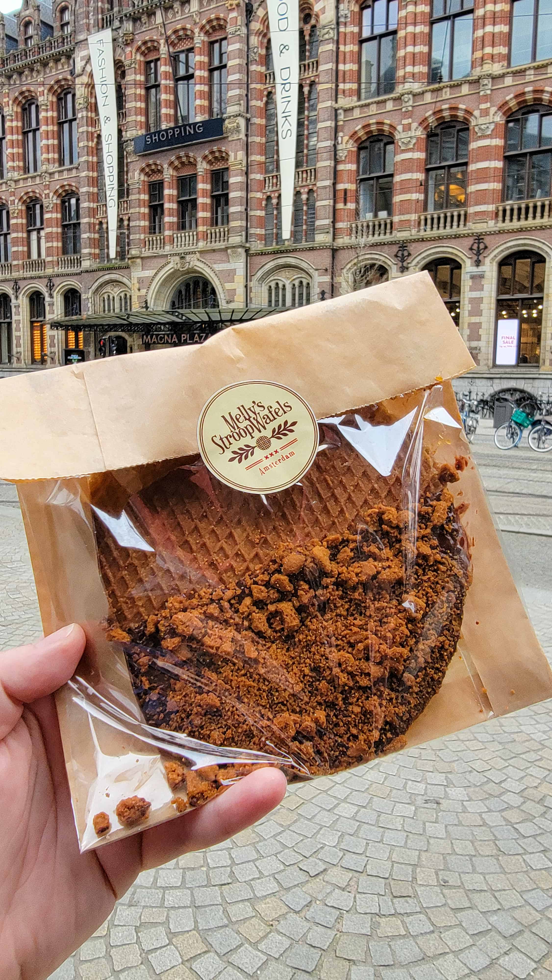 me holding a stroopwafel in amsterdam