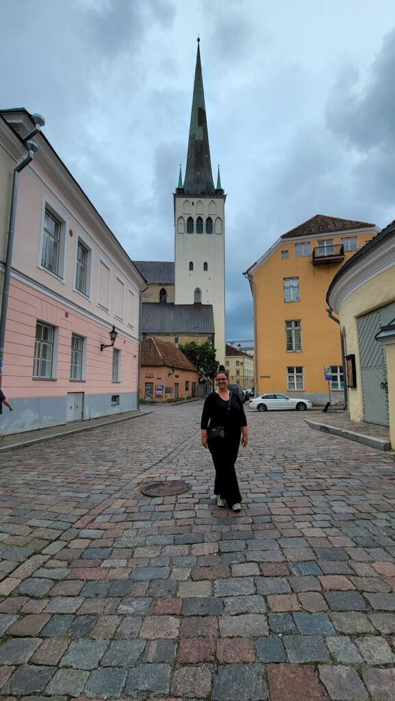 the author in front of st olaf church in tallinn