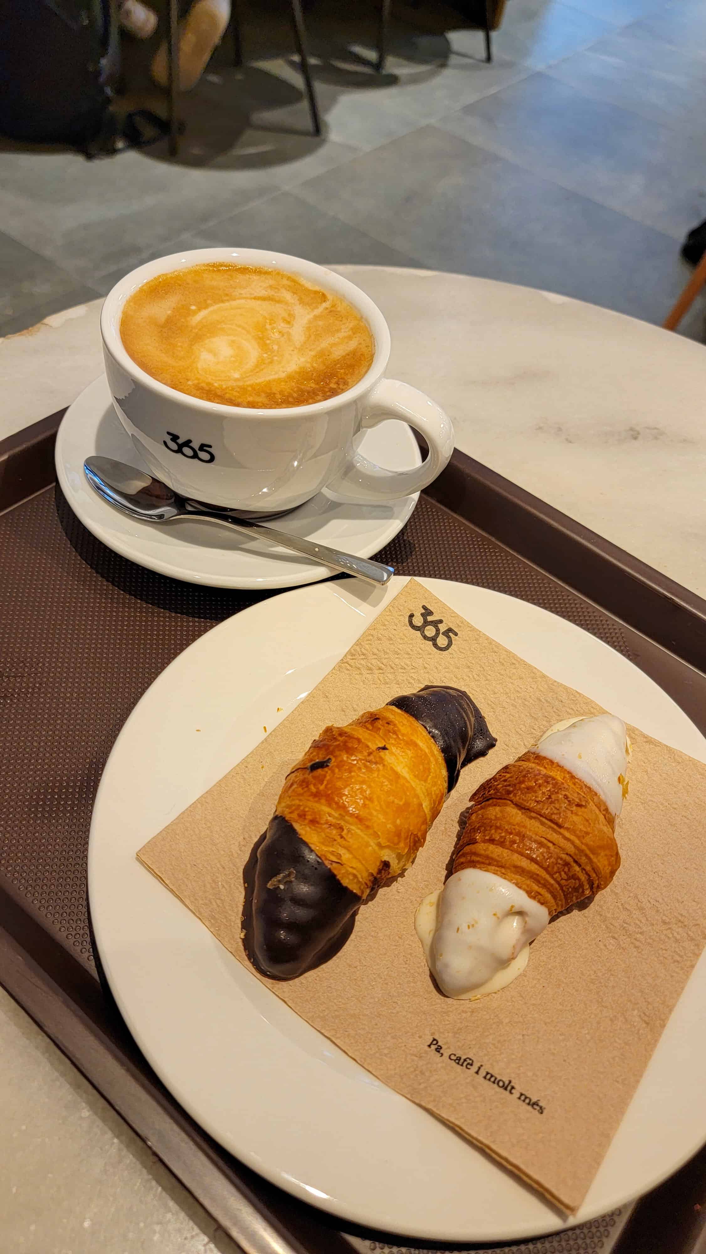 cafe con leche and croissants at a cafe in barcelona