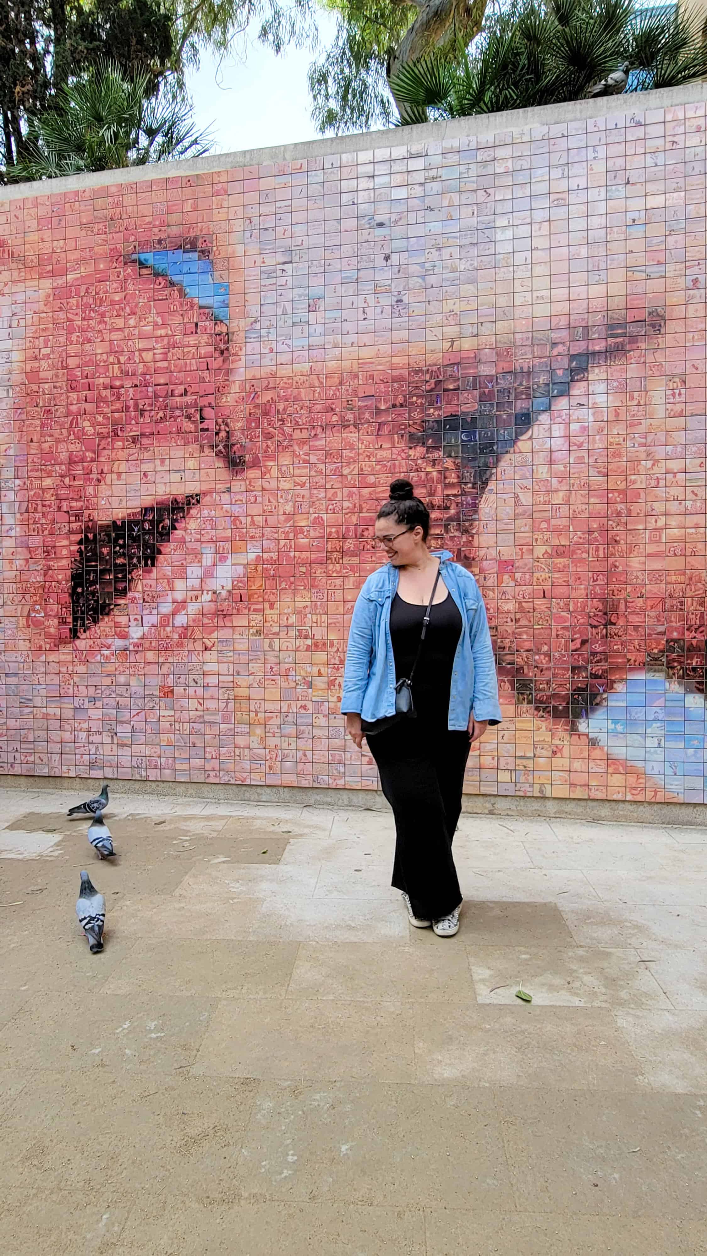 the author next to a mural in the gothic quarter in barcelona