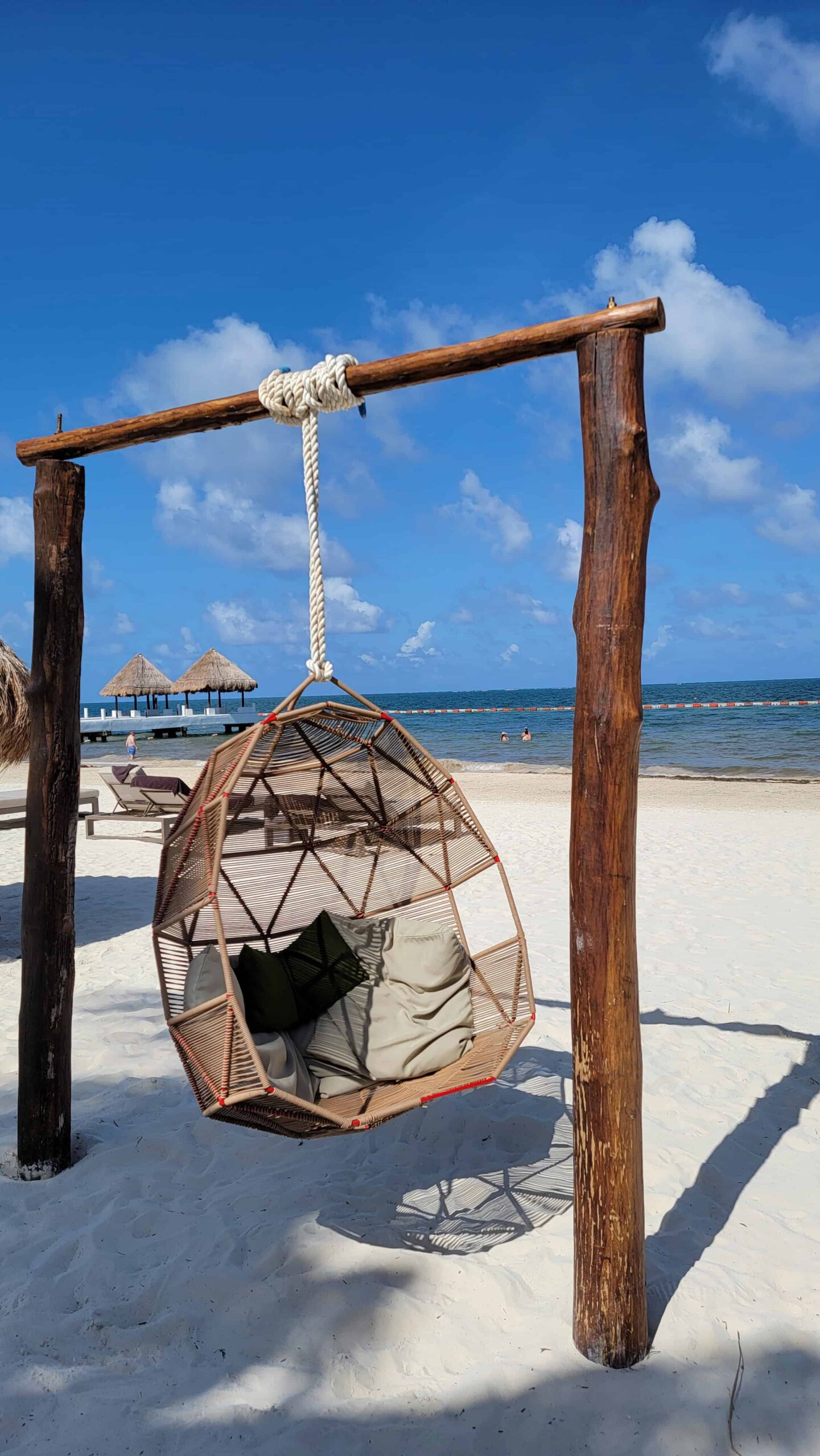 a chair on the beach in tulum