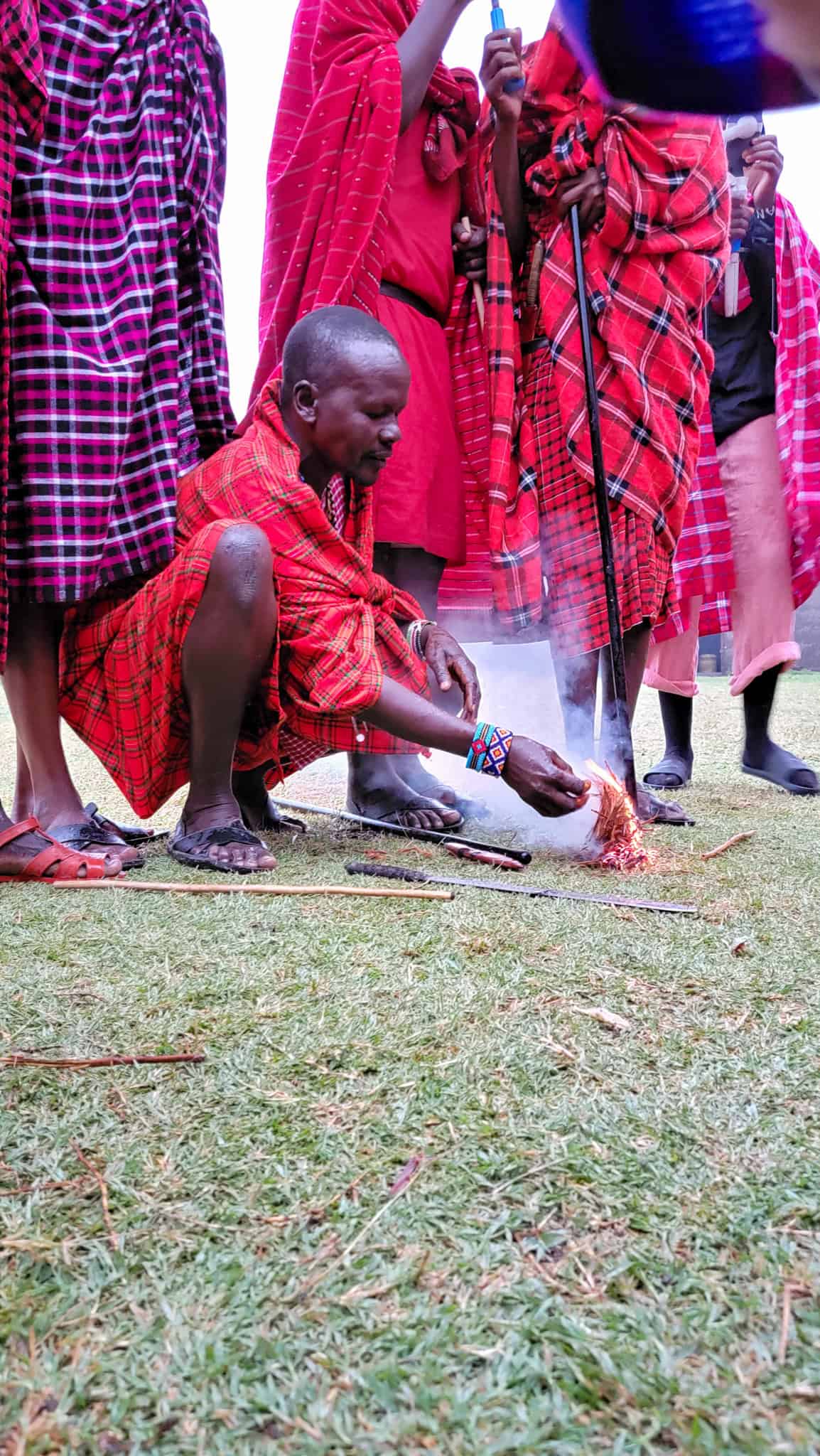 a maasai man lighting a fire