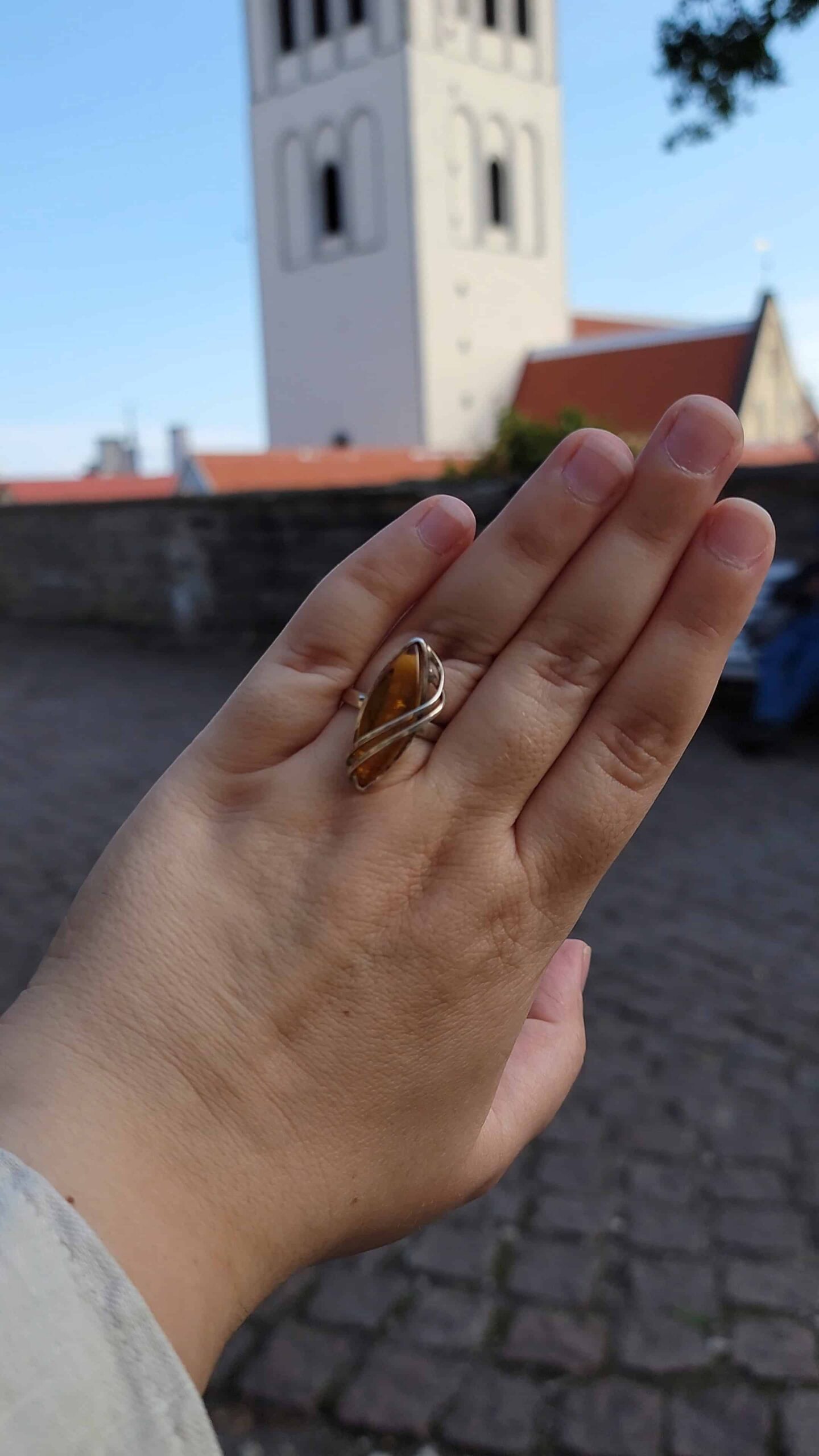 author's hand with an amber ring