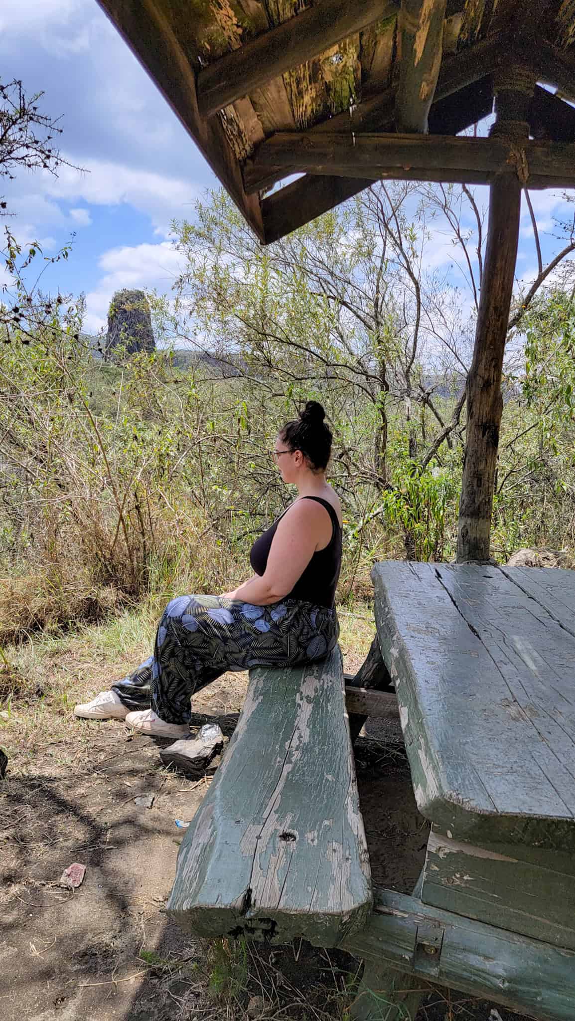 the author sitting down on a bench in a national park in kenya