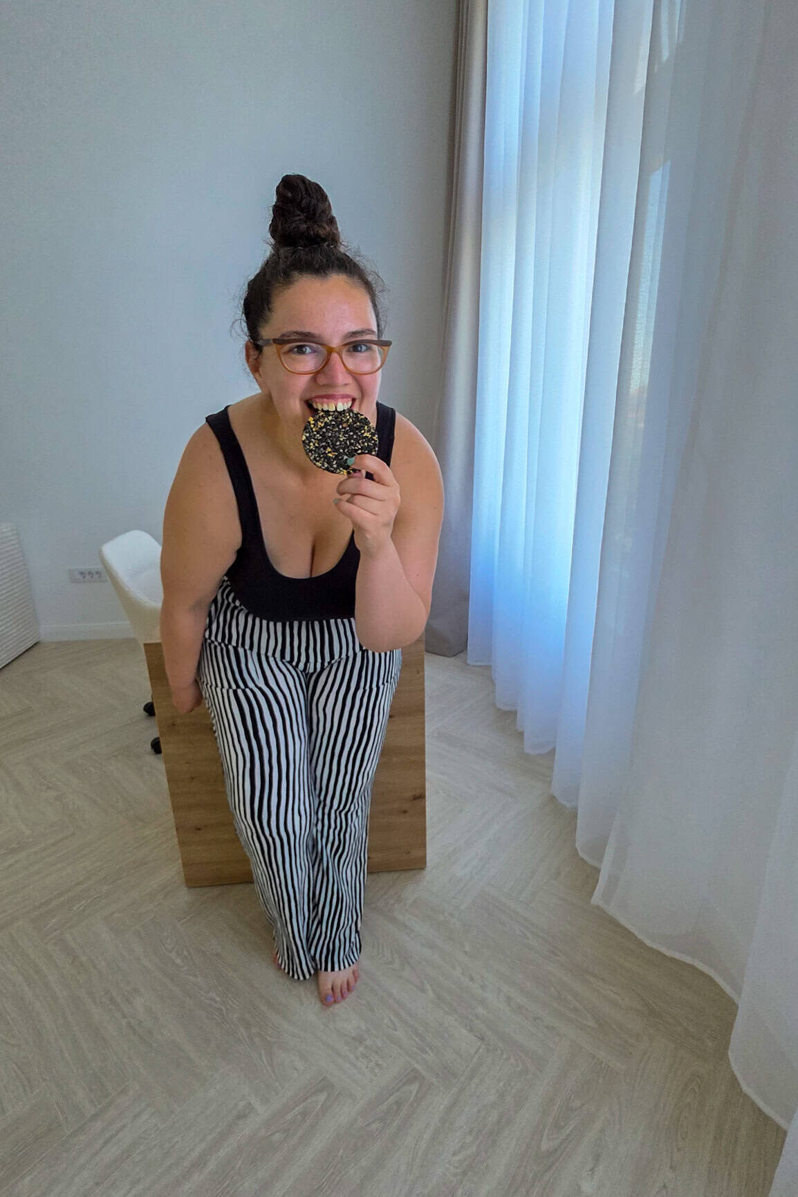 the author eating a black sesame treat from sakuraco's box