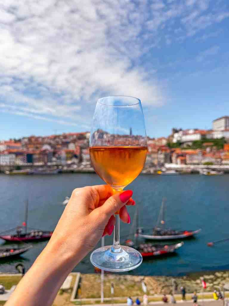 a glass of wine and the view from terrace lounge 360 porto