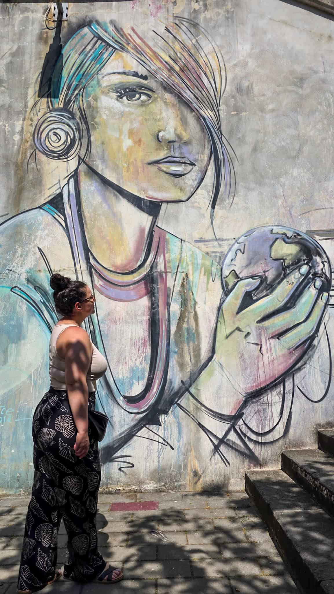 the author by a street art mural in salerno