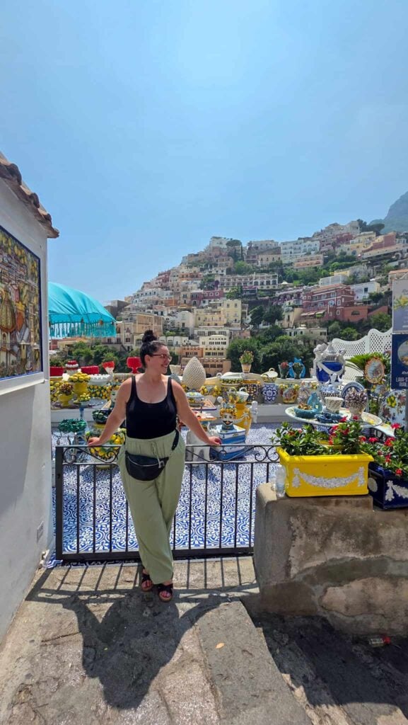the author in front of a terrace with ceramics in positano