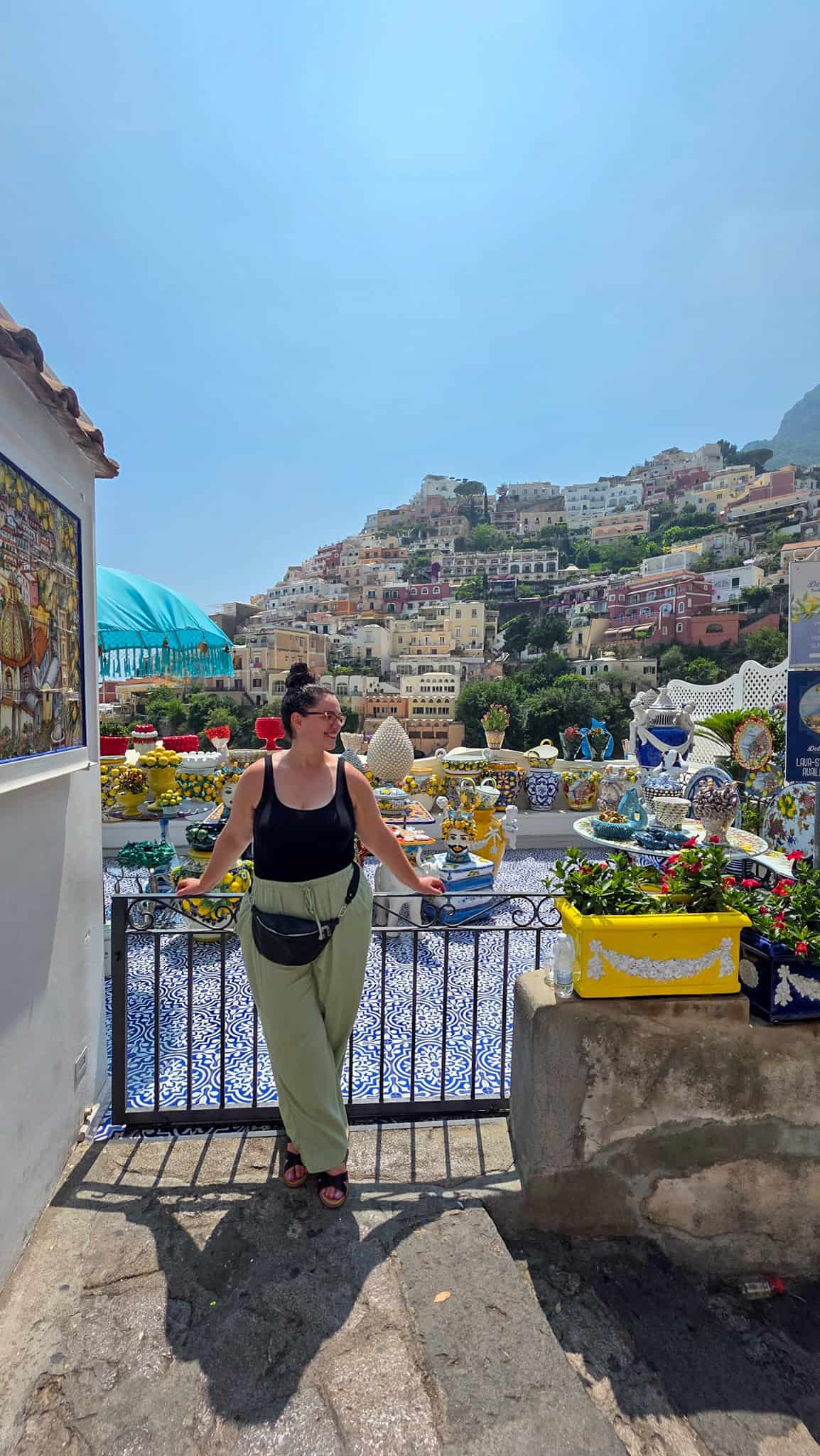 the author in front of a terrace with ceramics in positano