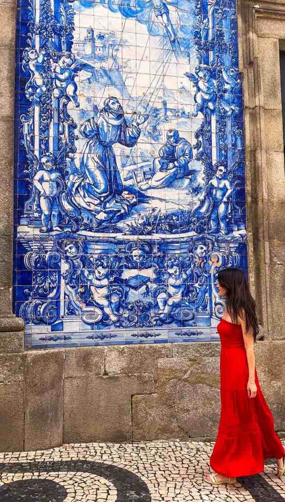 the author in front of azulejo tiles in Porto, on her 1 day in Porto itinerary