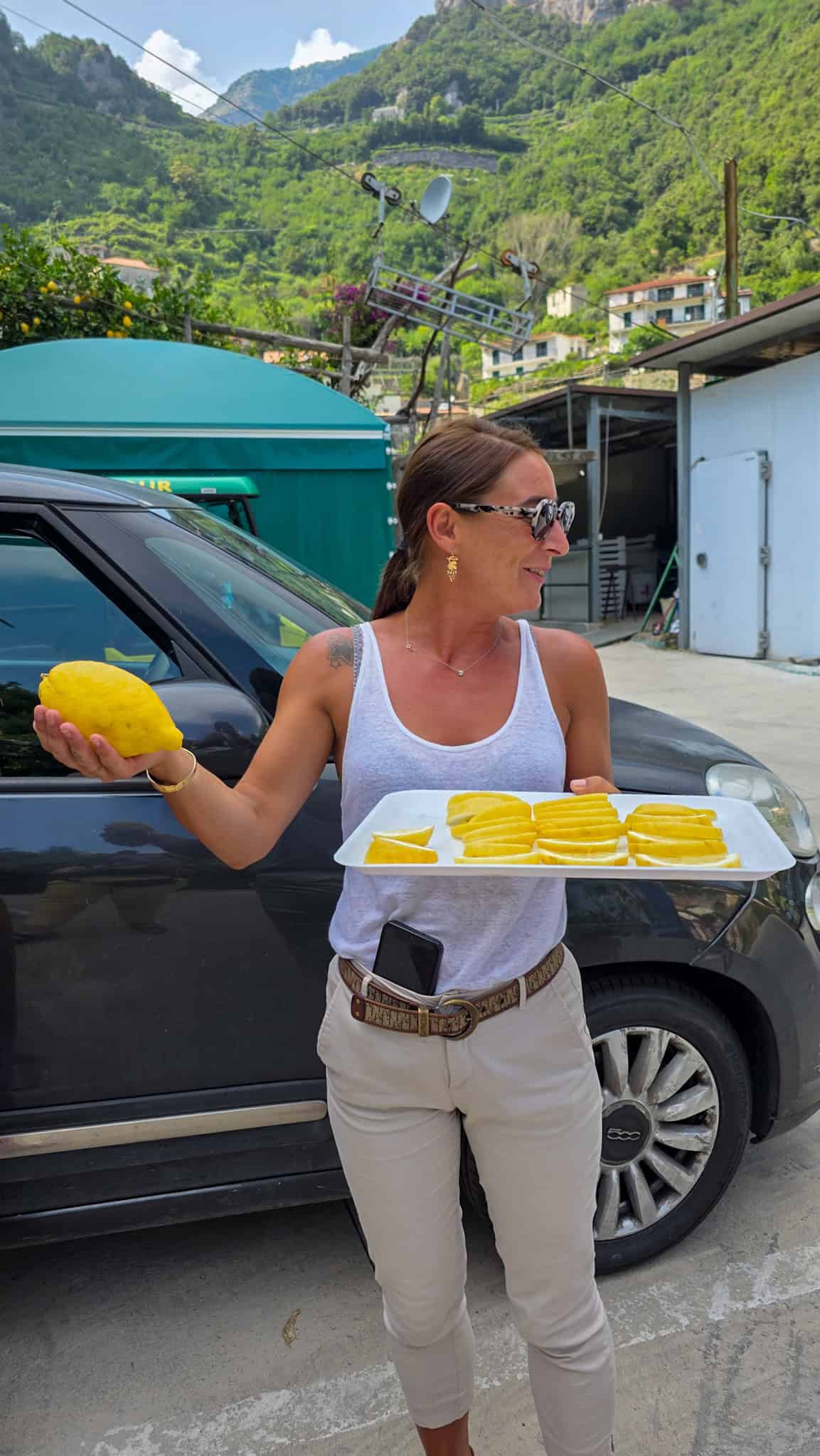 tour guide holding a plate of lemon slices