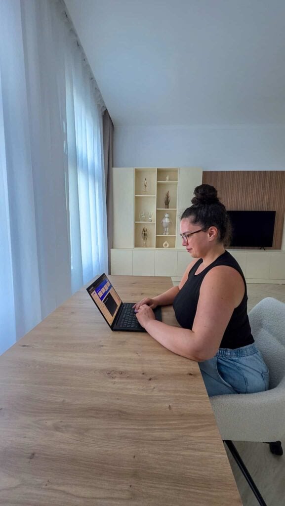 the author at her desk looking at her laptop