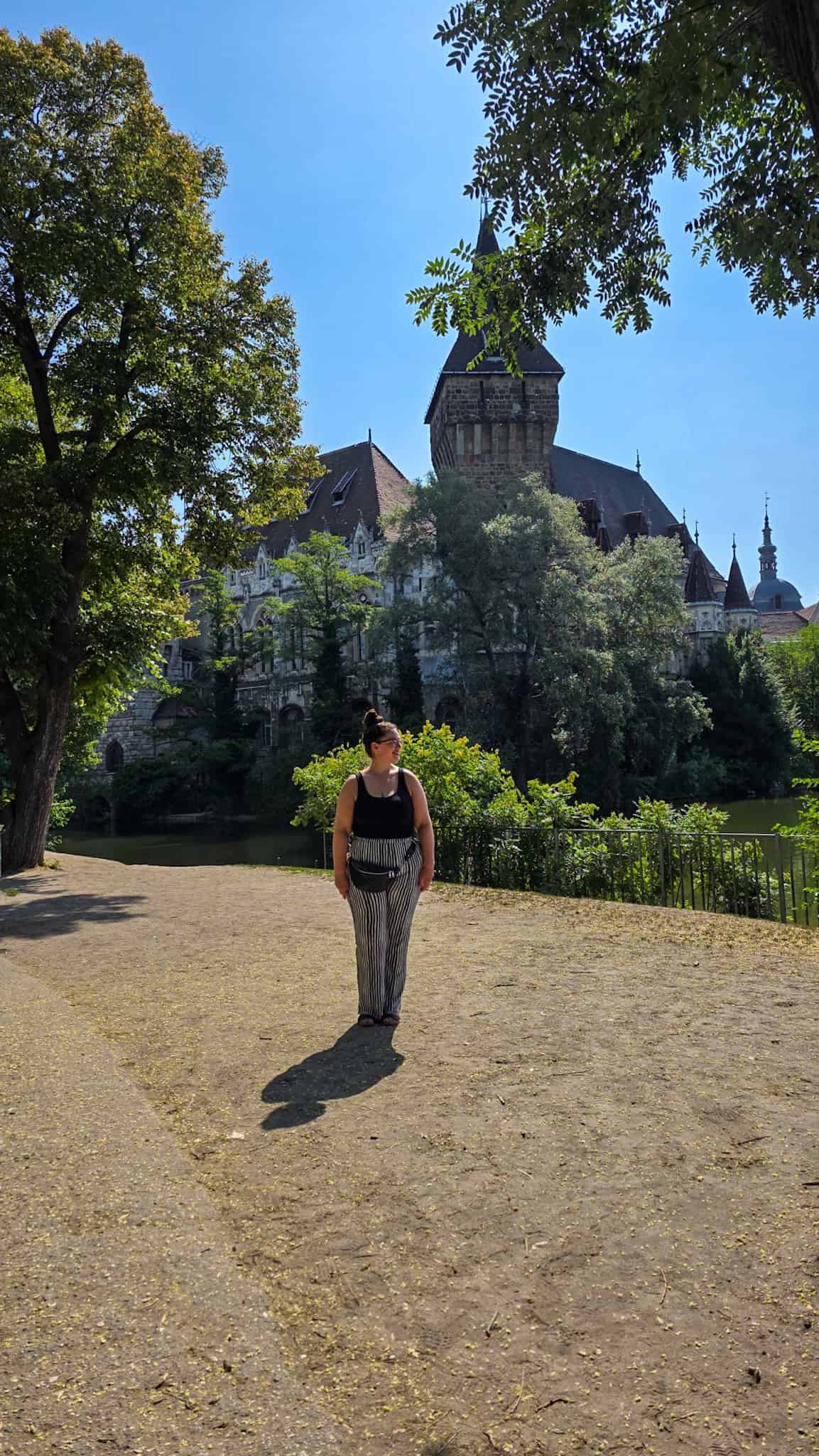 the author in front of vajdahunyad castle in budapest