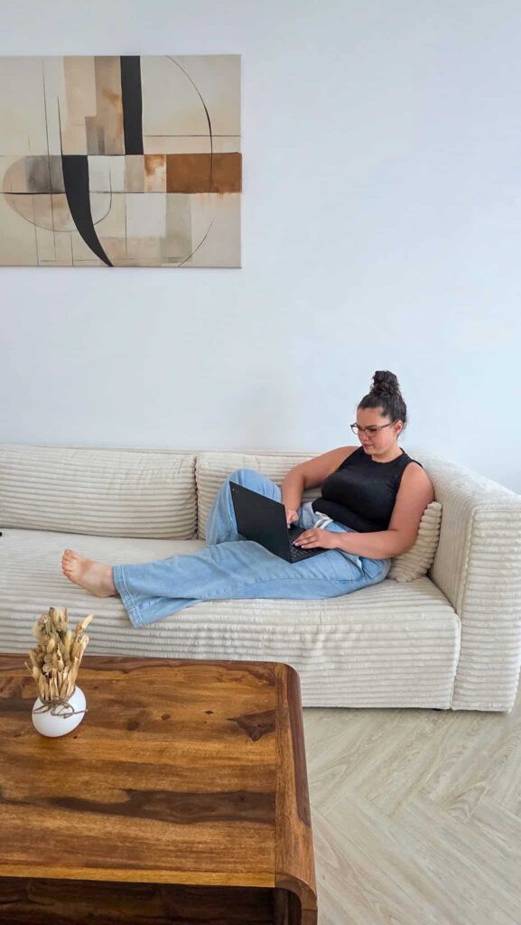 the author on a couch working on her blog