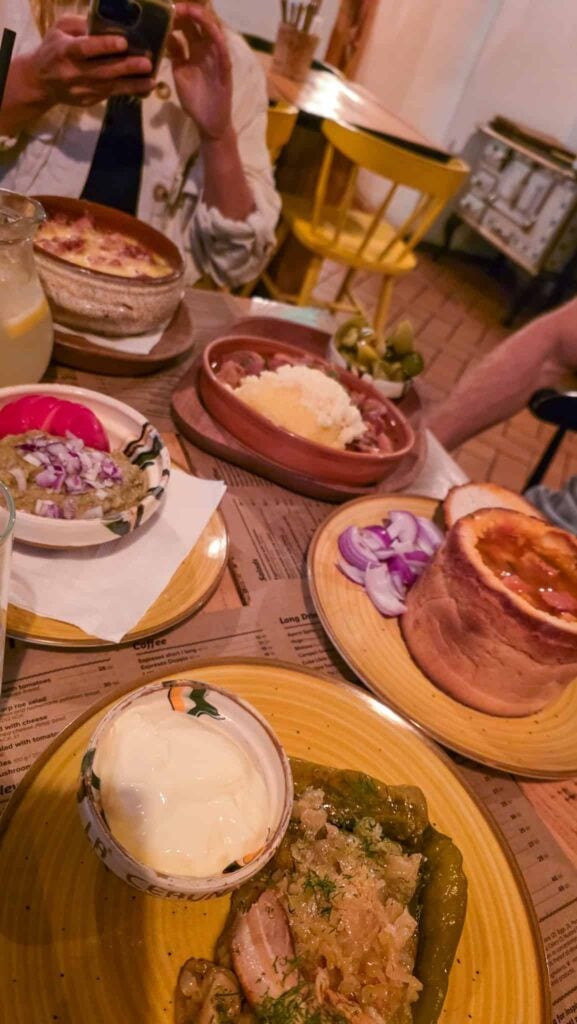 multiple plates of food at la ceaun restaurant in brasov