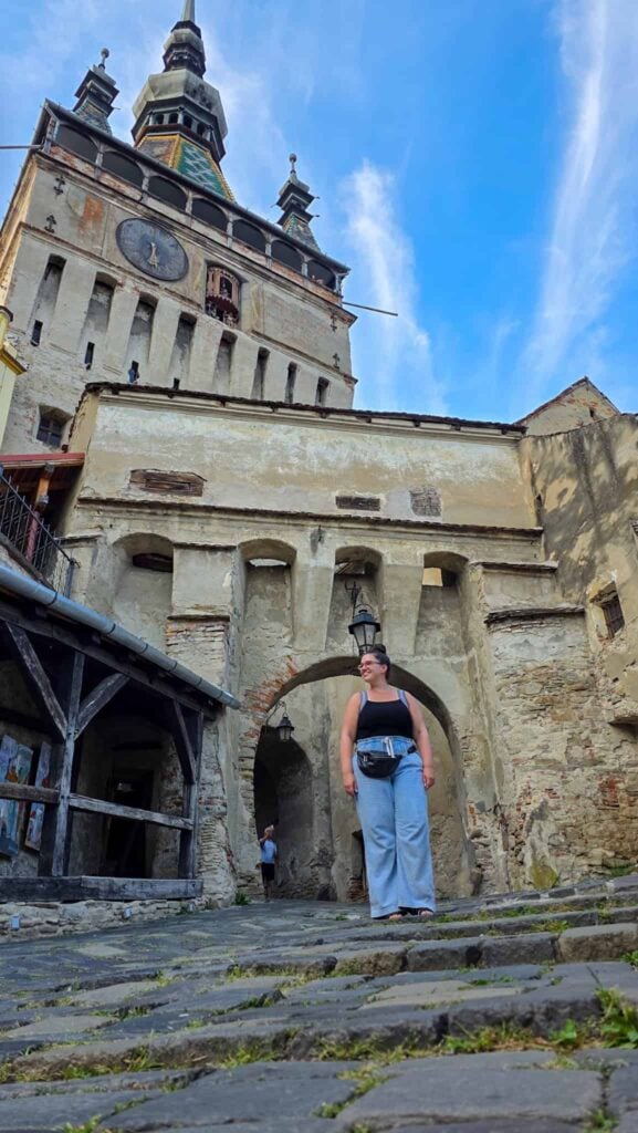 the author in front of the clock tower in sighisoara