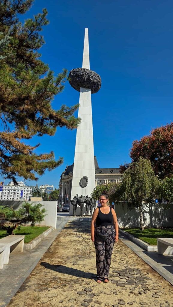 the author in front of the memorial of rebirth in bucharest