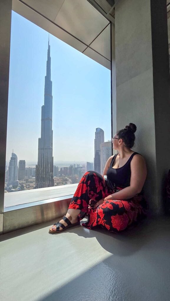 the author and a view of burk khalifa at sky views observatory in dubai