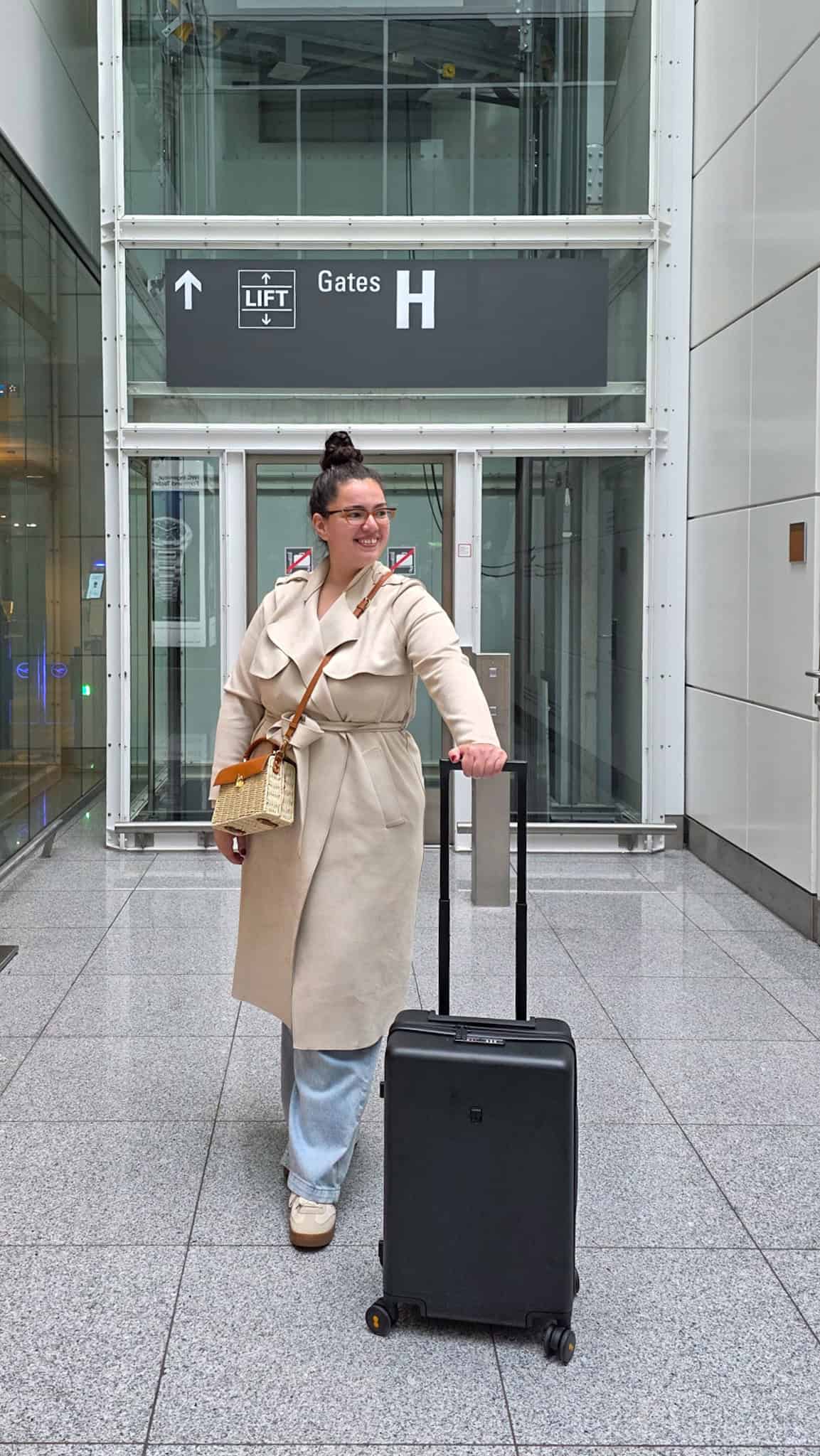 the author at the airport with her LEVEL8 suitcase, part of her LEVEL8 luggage review