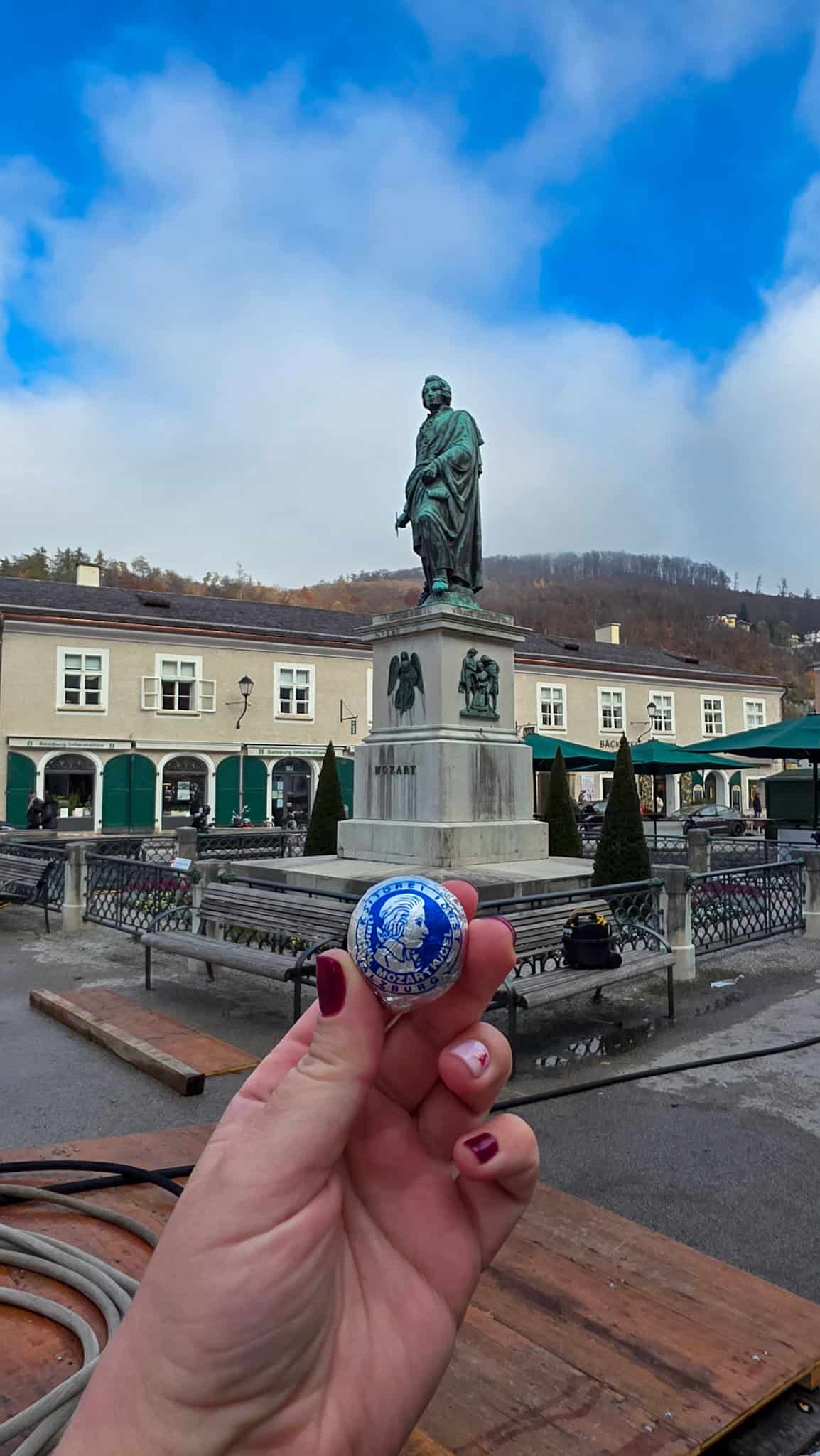 the author holding a mozart chocolate in salzburg