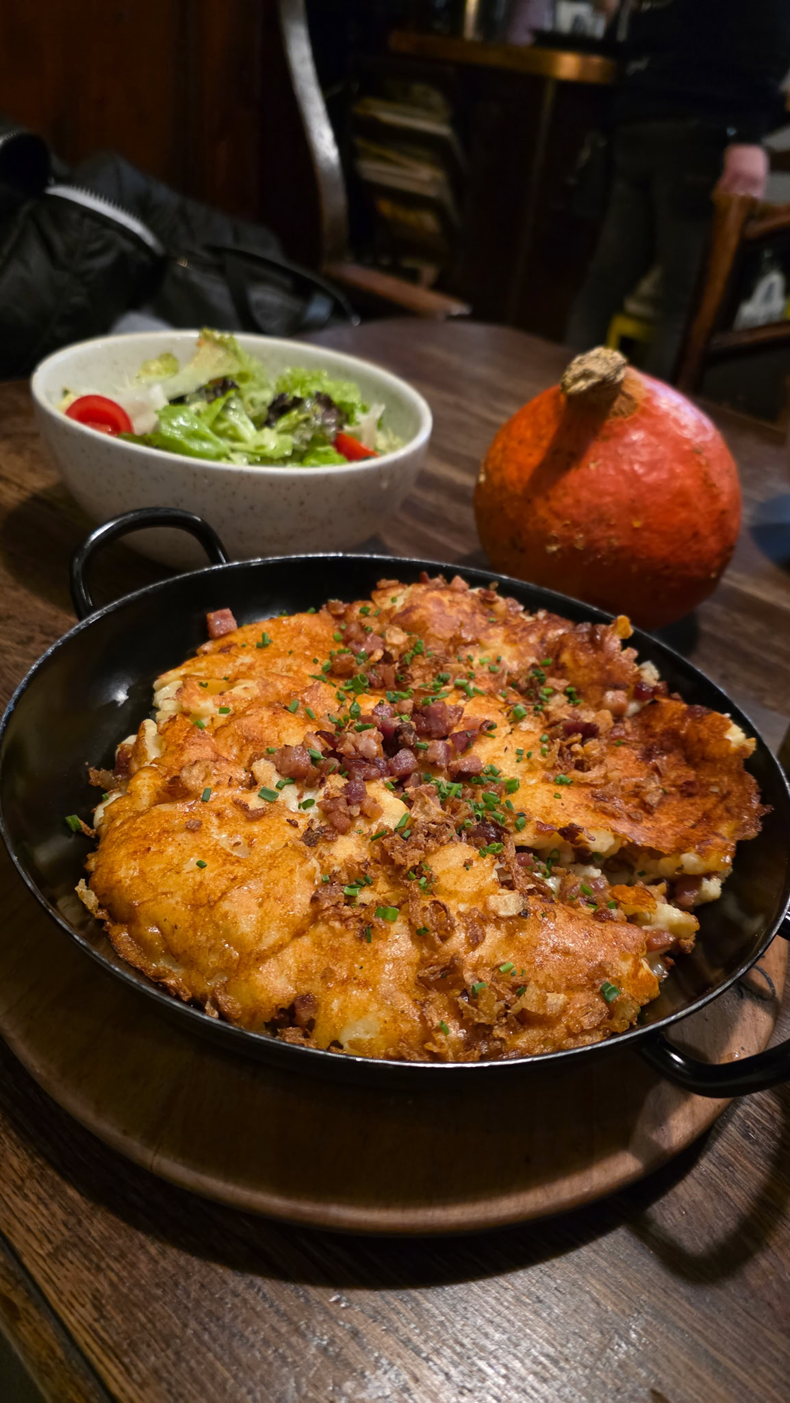 a plate of spatzle with cheese and bacon in salzburg