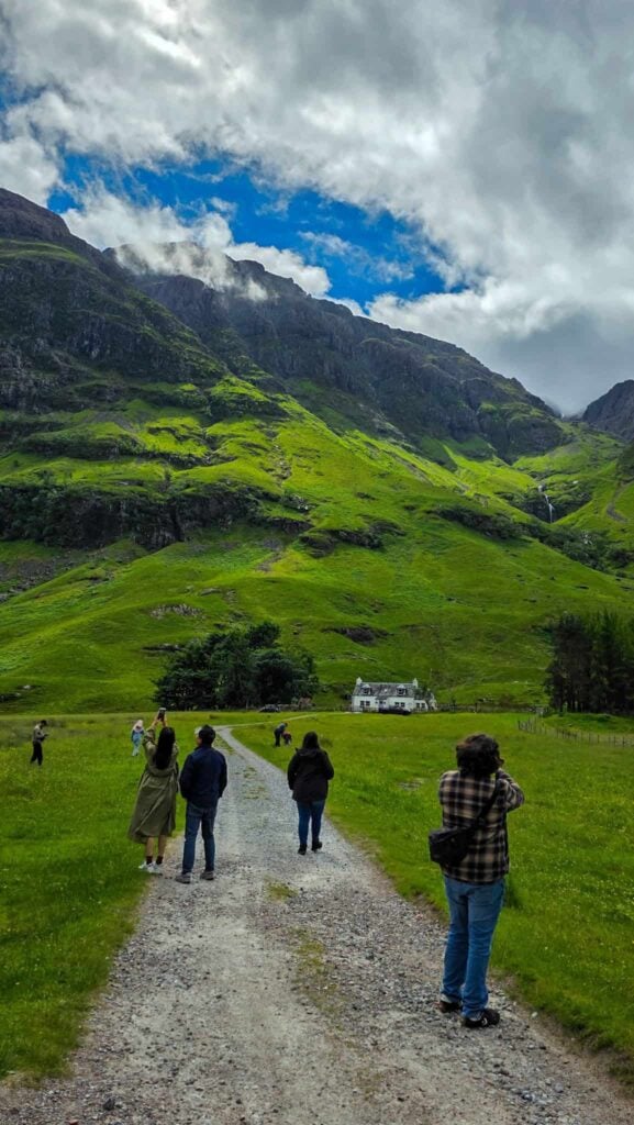 a remote house and tourists in the scottish highlands