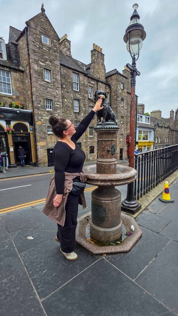 the author touching the nose of the bobby statue in edinburgh