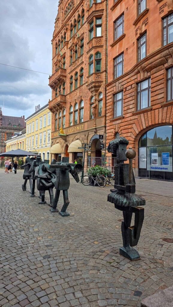 a street with sculptures in malmo