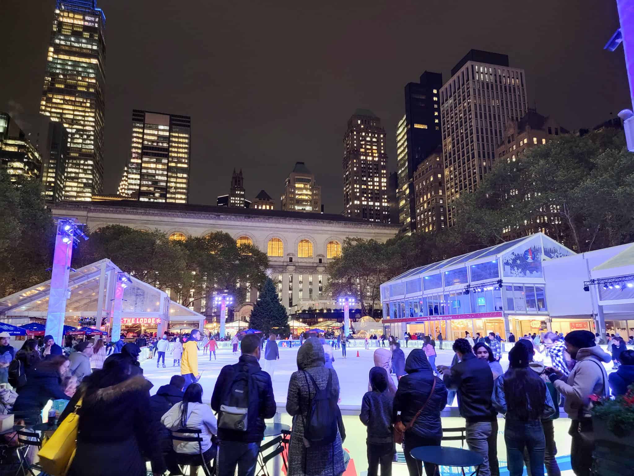 people by the ice skating rink at bryant park